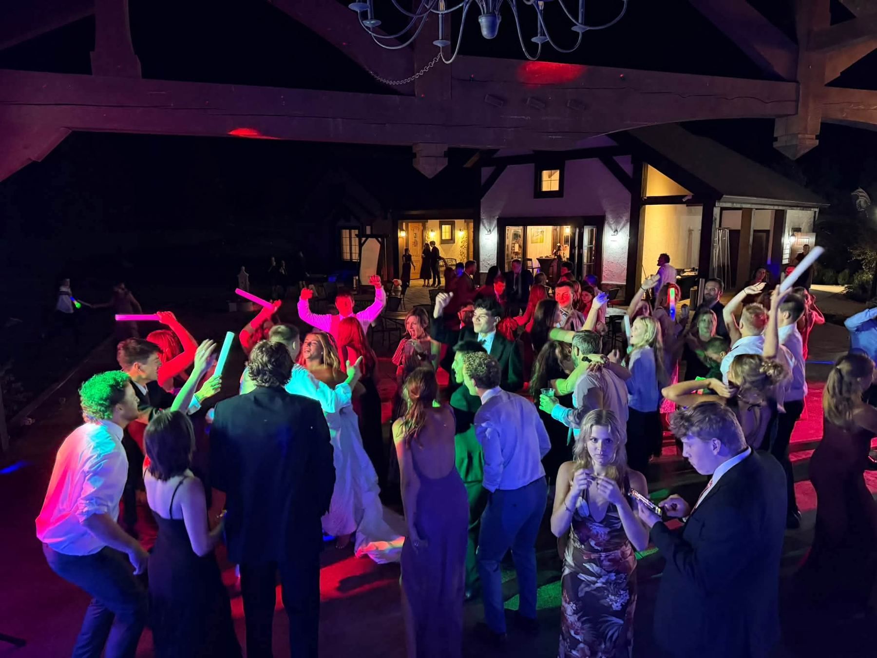 A bride dancing with her guests under the lights